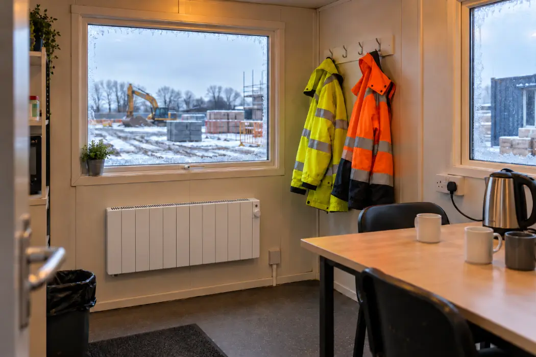 Electric panel heater in a site cabin welfare room on a frosty winter day